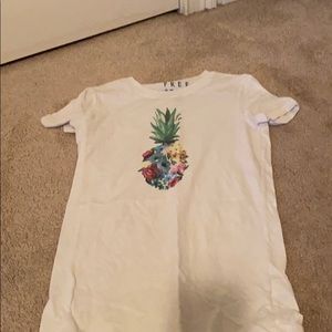 White tee with pineapple graphic